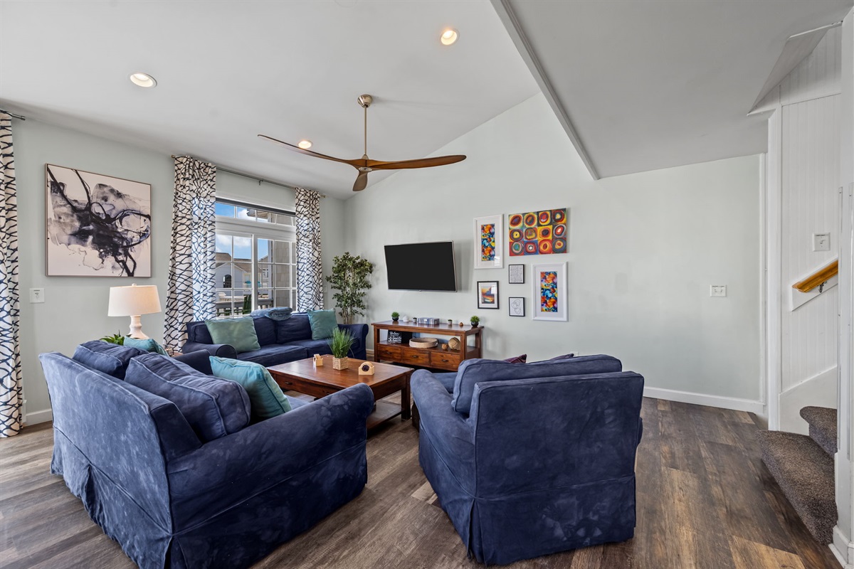 Living room with two full sofas and large chair.