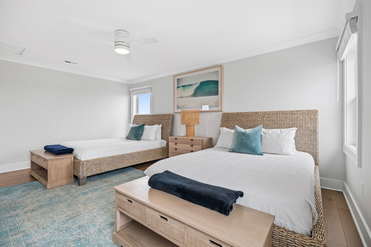 Bright and airy queen bedroom features stylish coastal d&eacute;cor and ample space to relax after a day by the water