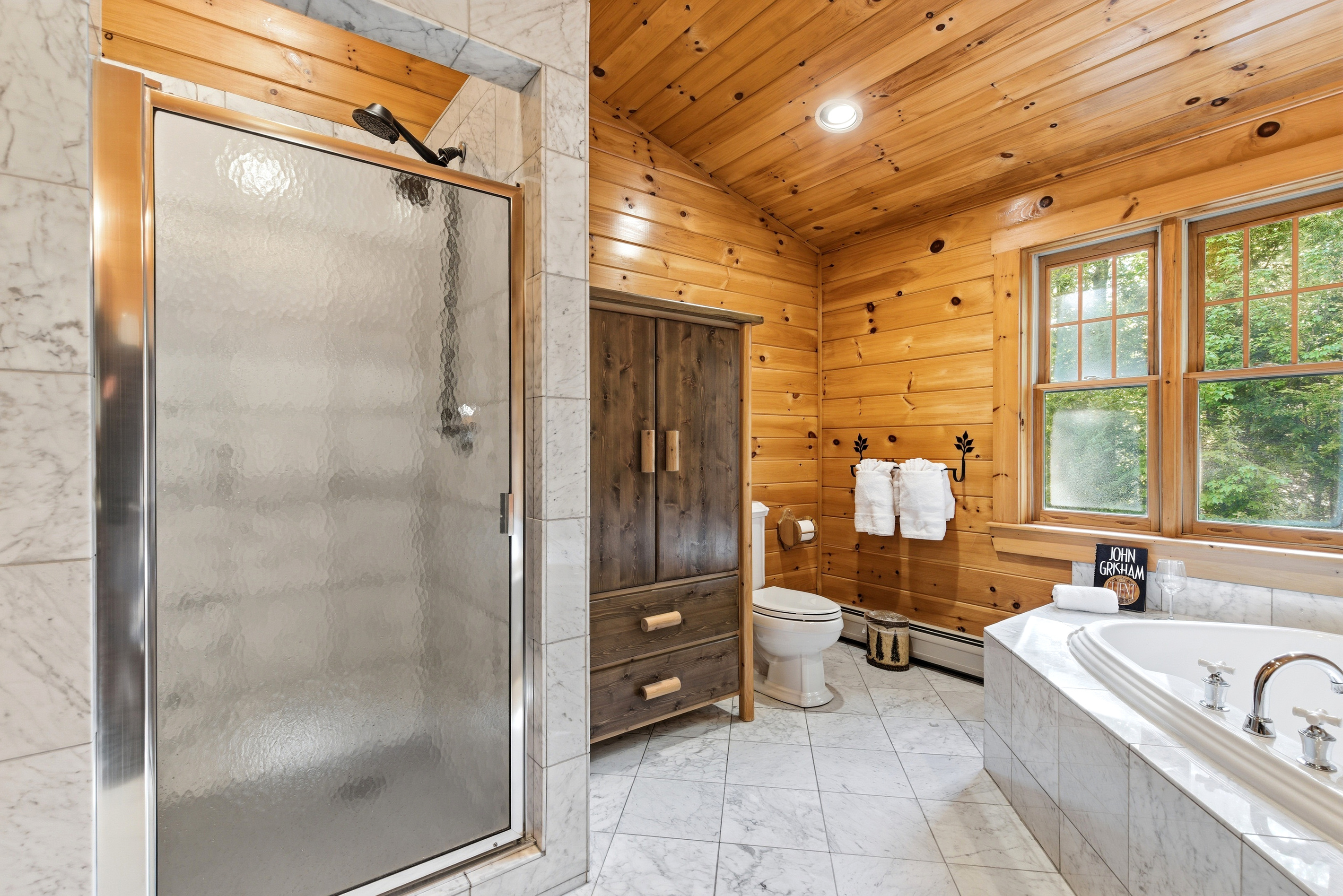 Spa-inspired bathroom with a large walk-in shower and elegant rustic finishes.