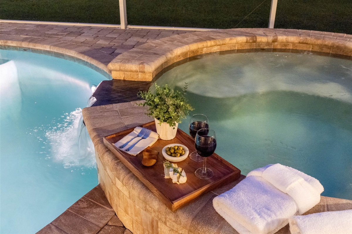 Adjacent to the pool is the inviting spa, a luxurious hot.