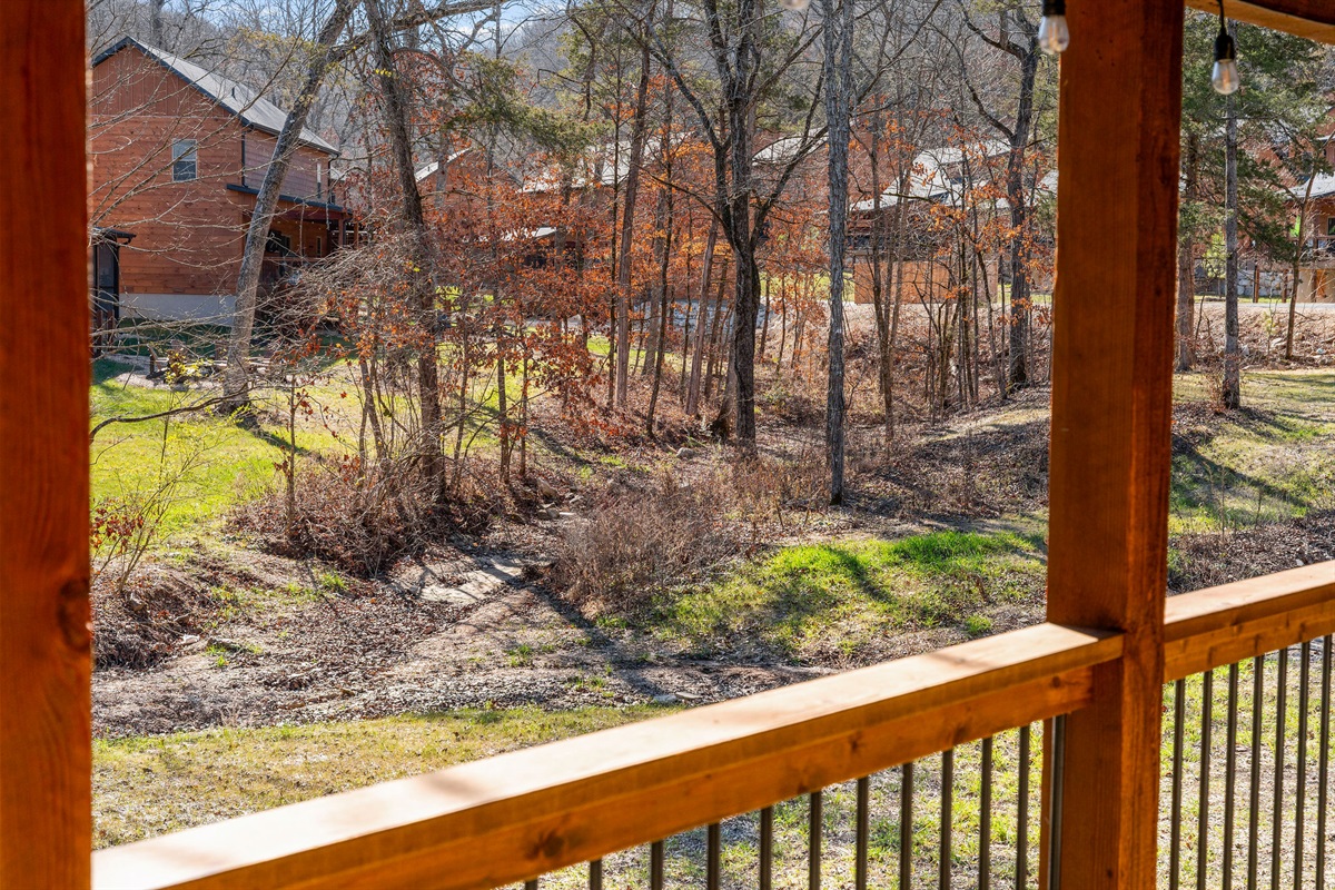 Peaceful wooded surroundings offering a quiet, natural backdrop with a creek bubbling through.