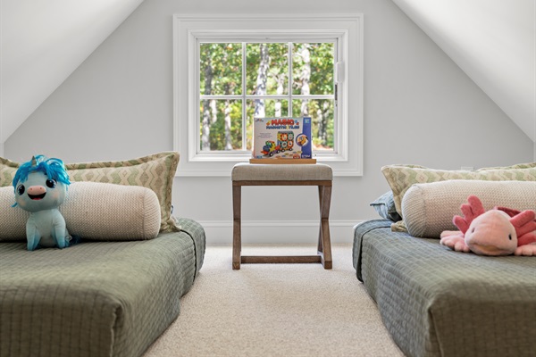 With a queen and two twin beds, this bedroom  offers space and flexibility for guests of all ages.