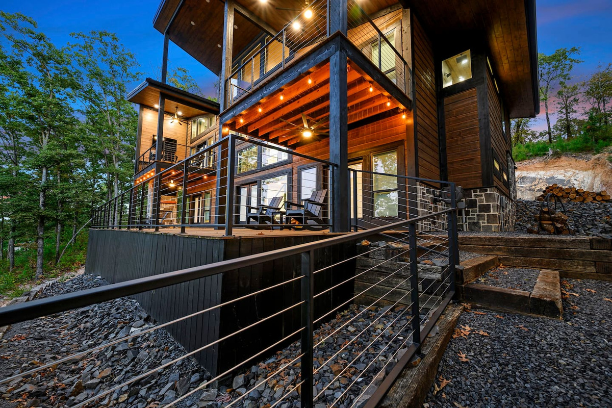 Covered decks and outdoor seating at Fossil Rock, surrounded by the wooded mountain setting.