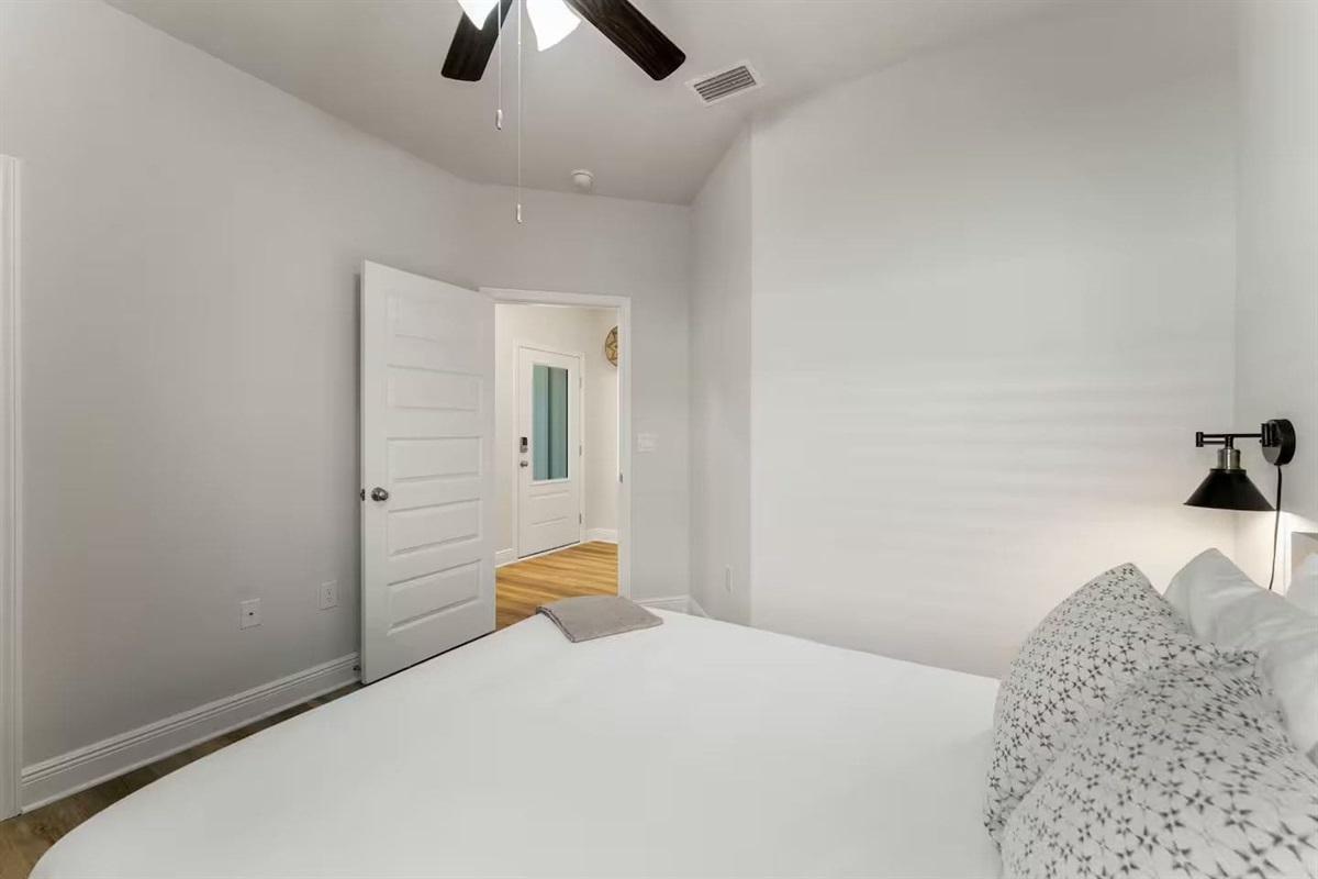 Modern bedroom with ceiling fan, and elegant bedside table lamps