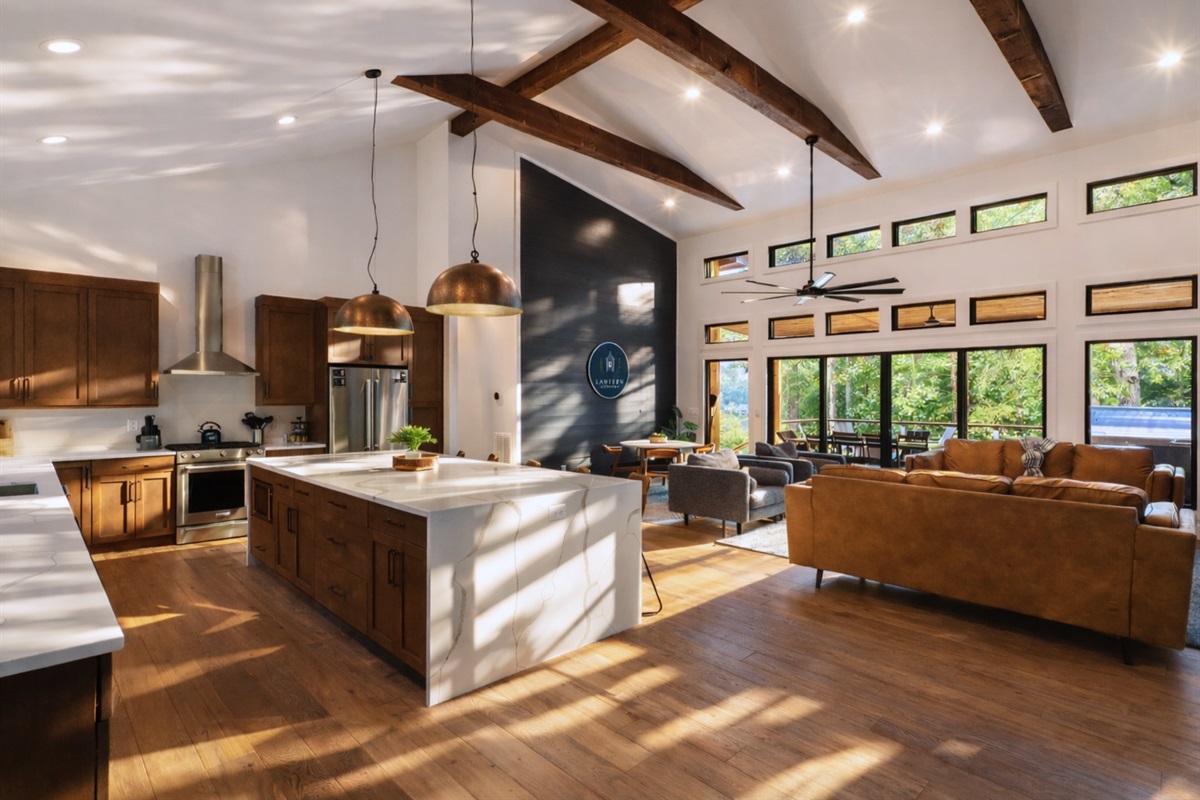 An overall view of the modern kitchen and living area, blending contemporary design with a cozy cabin vibe.