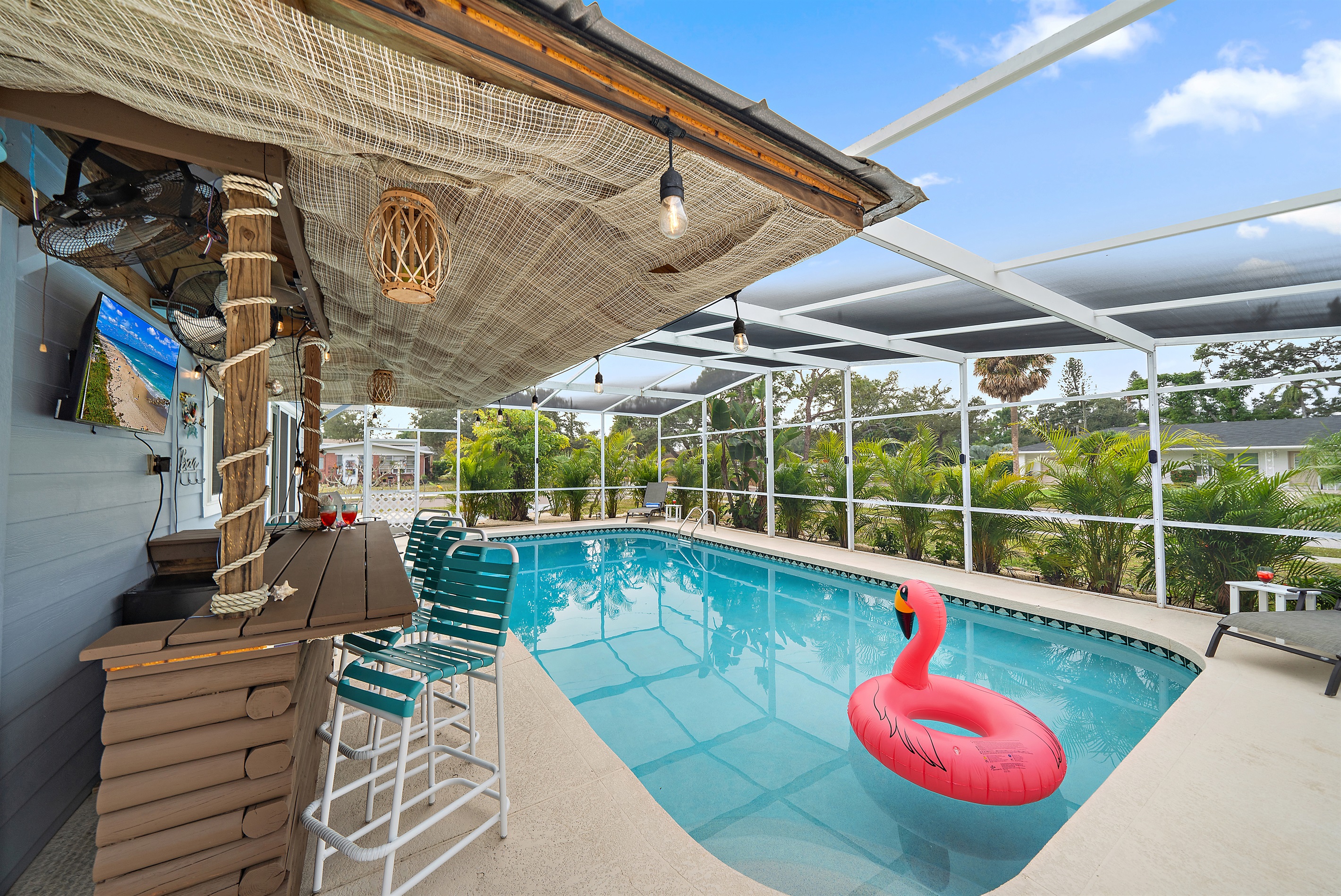 🍸 Sip, sit, and relax at the tiki bar featuring a 40" TV and five comfy bar stools.