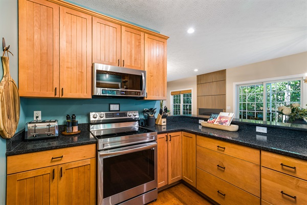 Cook with ease in a fully equipped kitchen featuring stainless steel appliances, plenty of counter space, and everything you need to whip up family feasts.