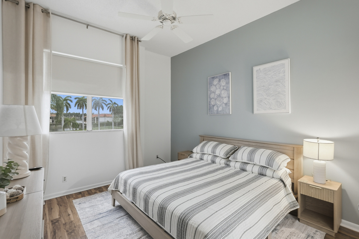 Unwind in the spacious primary bedroom, featuring a comfortable king-size bed, private ensuite bathroom, and Smart TV. After a day of soaking up the Florida sunshine, settle in, relax, and enjoy a peaceful night's rest.
