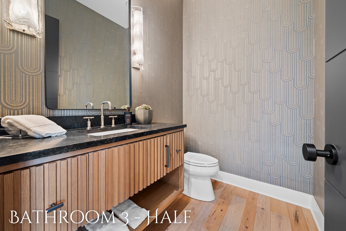 The clean lines and sophisticated decor of this half bathroom make it a stylish and functional space.