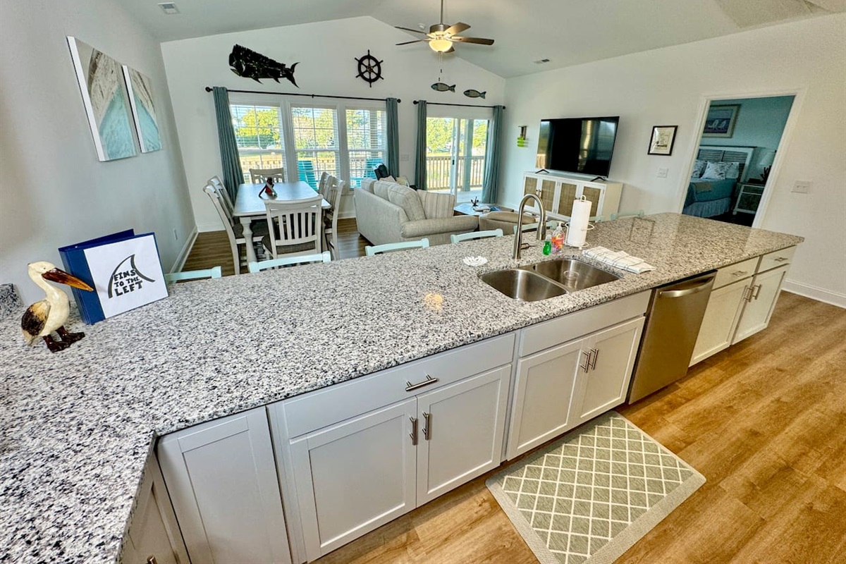 Enjoy cooking in this fully stocked kitchen with a custom island and ample bar seating. 