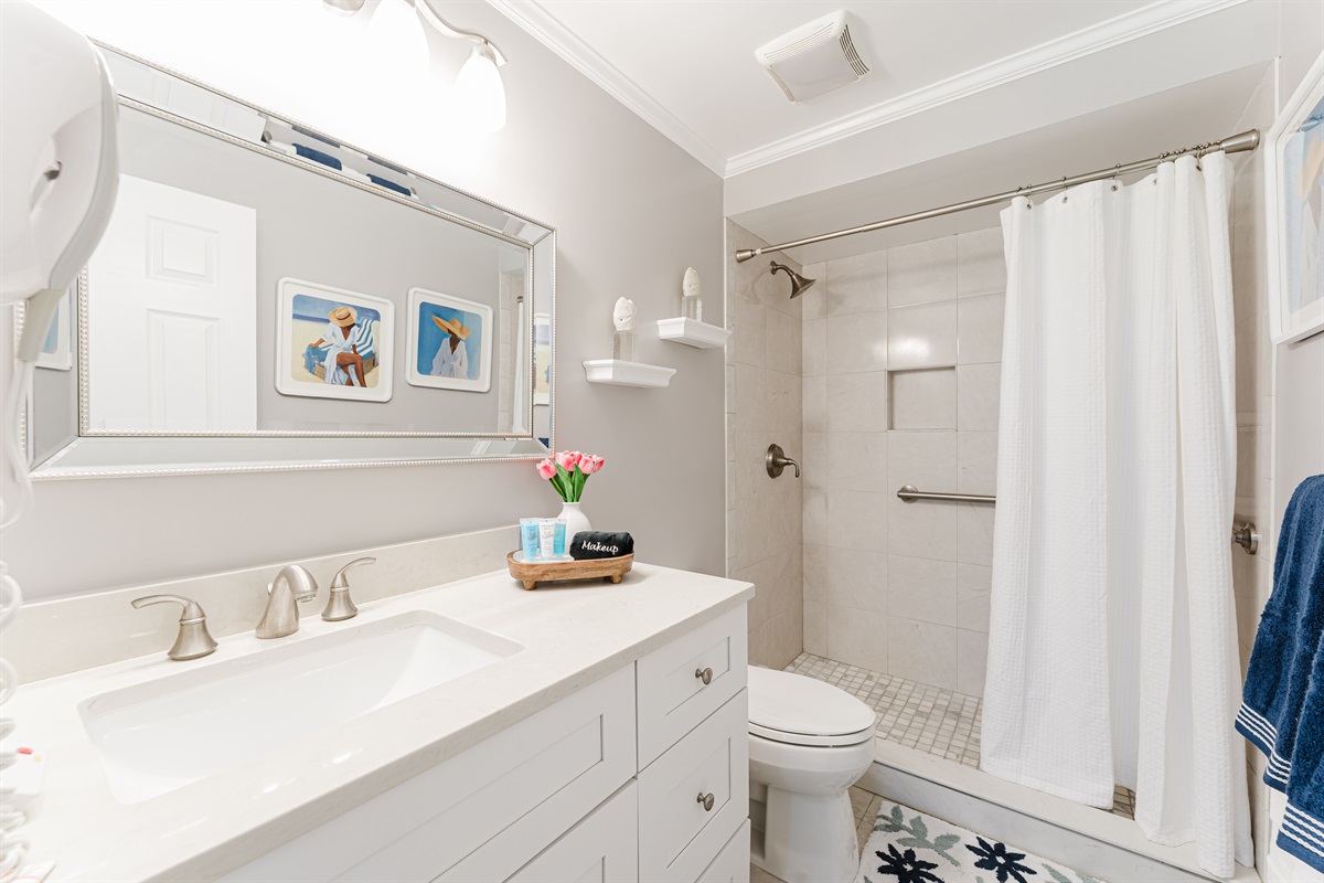 Bright, modern ensuite bathroom with a walk-in shower and clean coastal finishes
