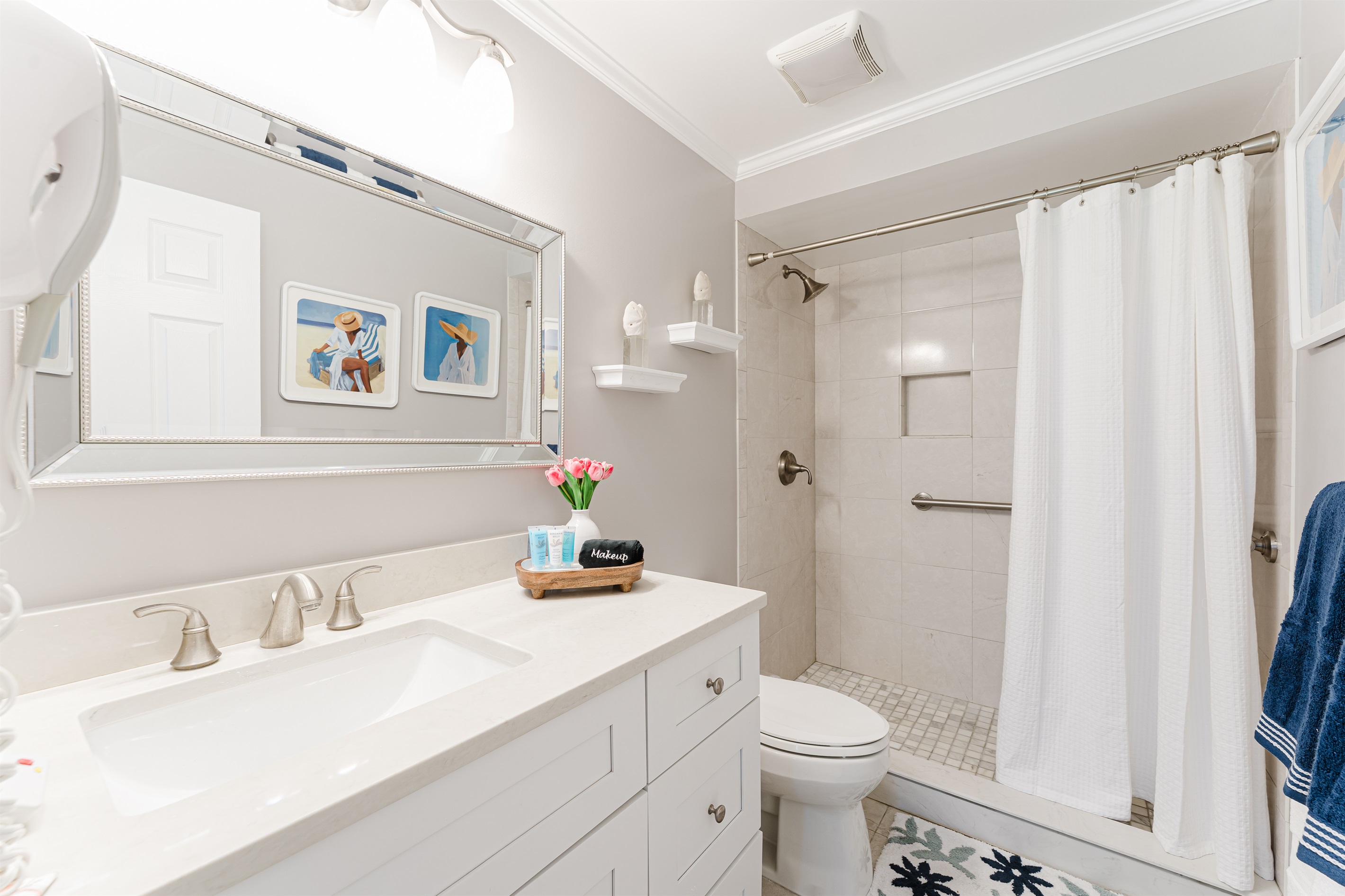 Bright, modern ensuite bathroom with a walk-in shower and clean coastal finishes
