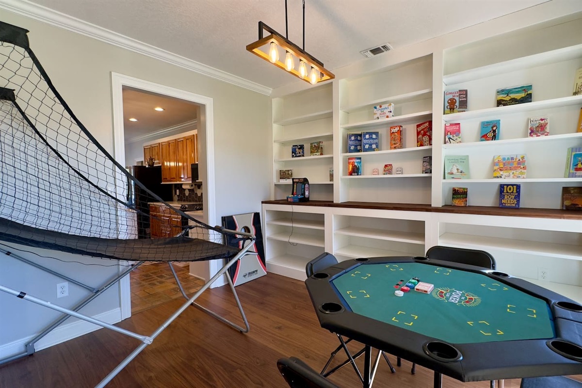 Basketball arcade game and poker table set the stage for fun and friendly competition.