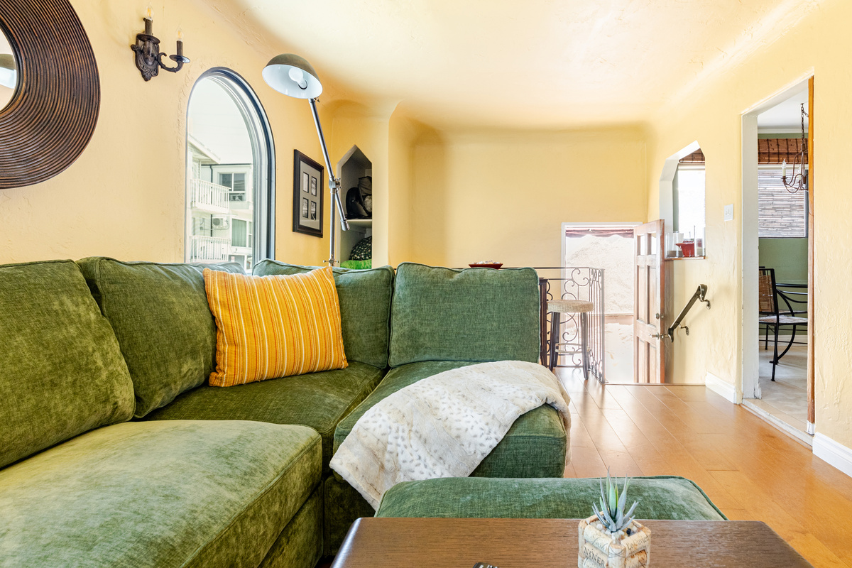 Walk through the front door, climb a few stairs and enter the living room with a comfortable Lovesac couch, flat screen TV, laptop workstation, and gas fireplace.
