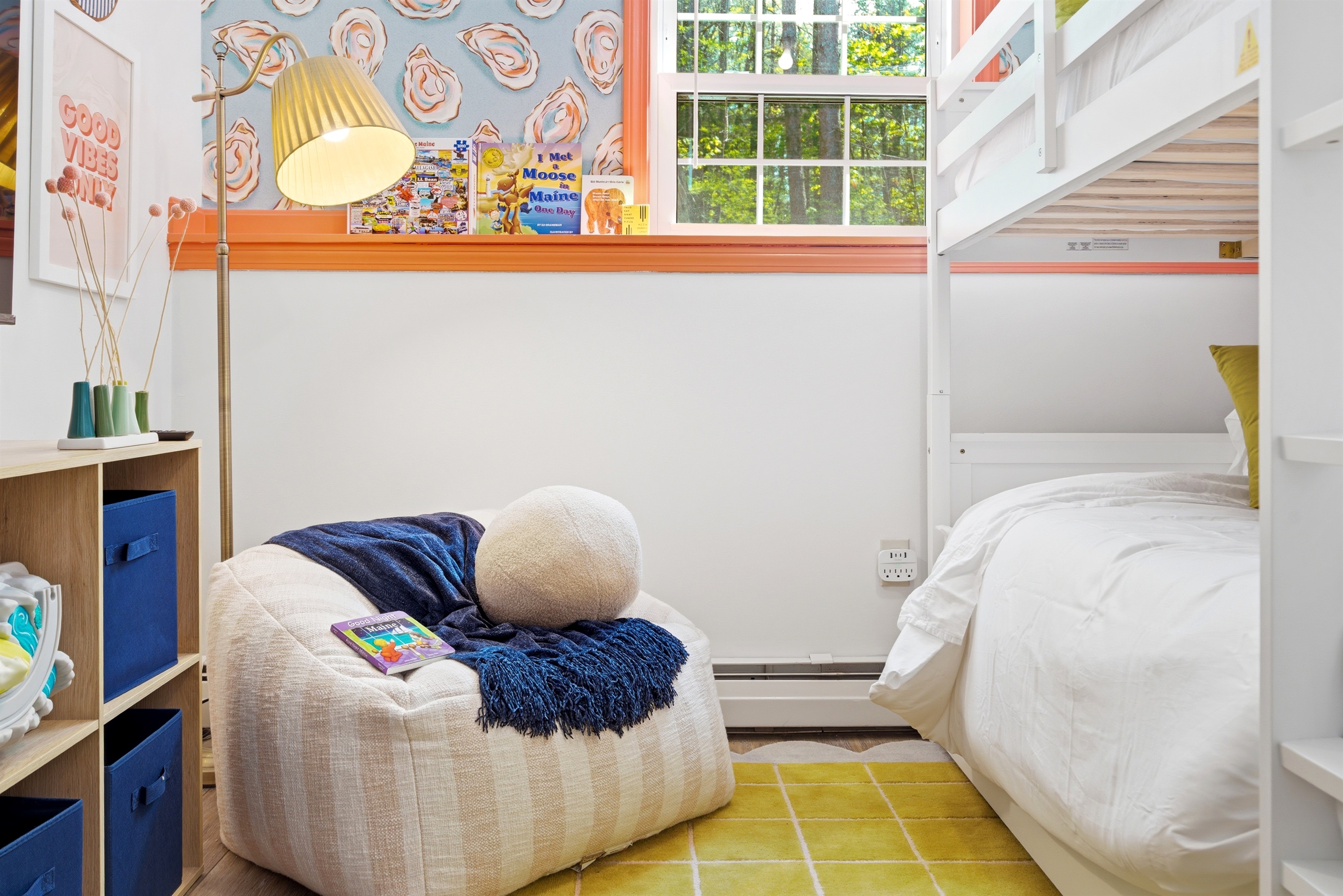 A cozy bean bag placed beside a bunk bed, creating a relaxed and comfortable corner perfect for lounging, unwinding, or for families, reading the kids a bedtime story.