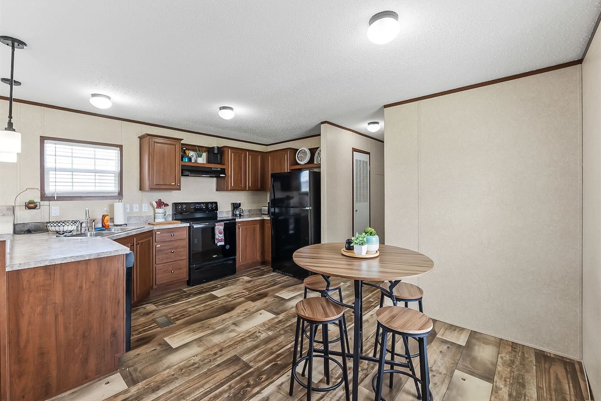 Open-concept kitchen and dining area with stylish wood finishes and comfortable seating for shared meals.