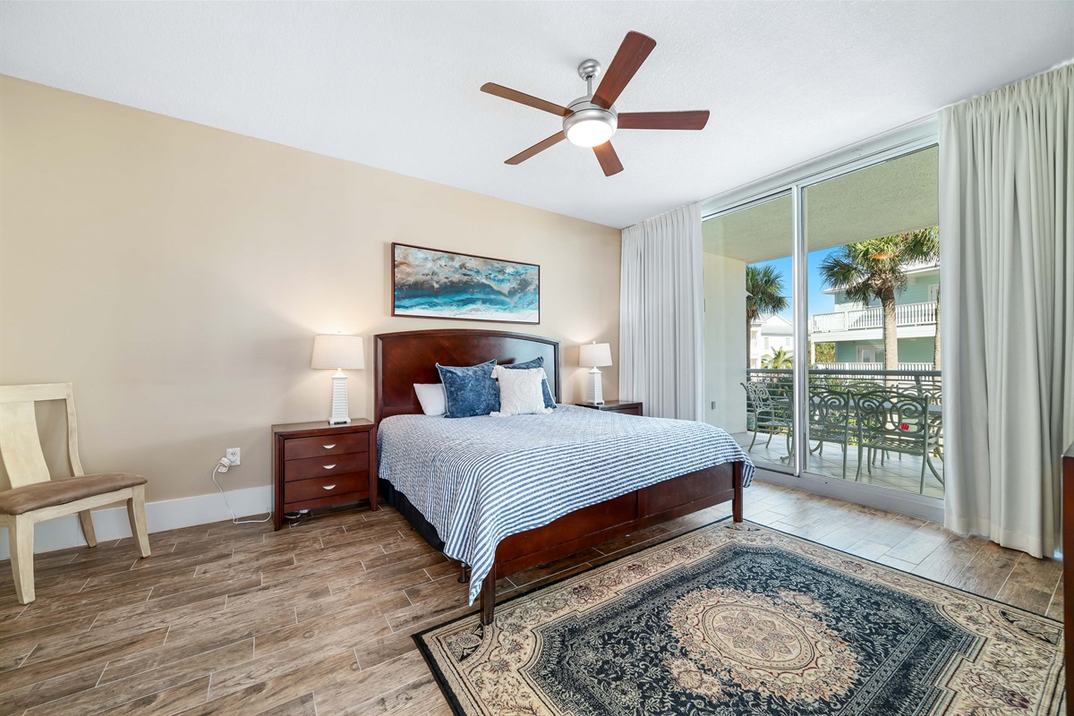 Enjoy the perfect blend of comfort and coastal beauty in this inviting primary bedroom with king-size bed and direct balcony access.