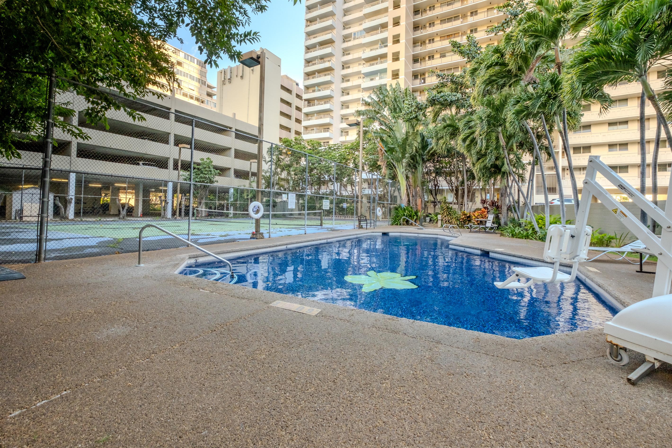 Dive into relaxation in this tranquil Waikīkī pool surrounded by tropical palms and warm island air