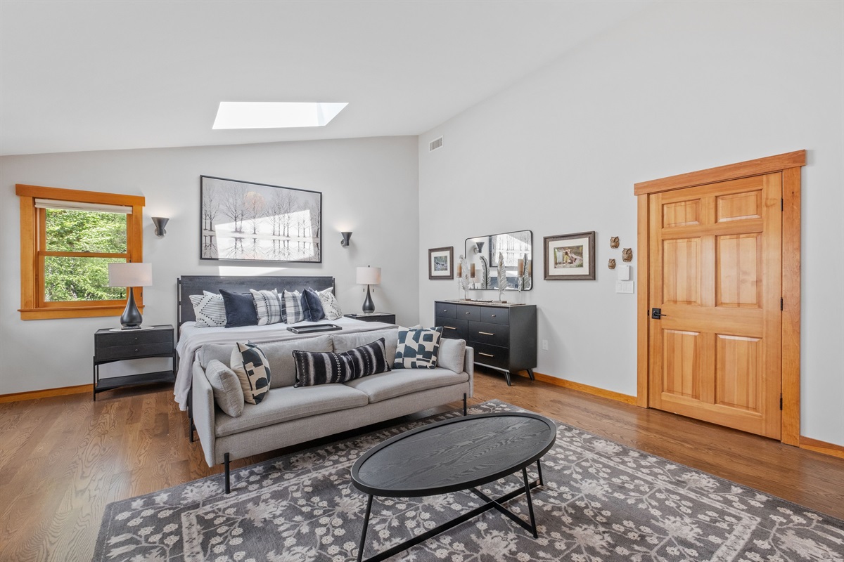 Second floor master bedroom ensuite with king bed and couch and its own bathroom