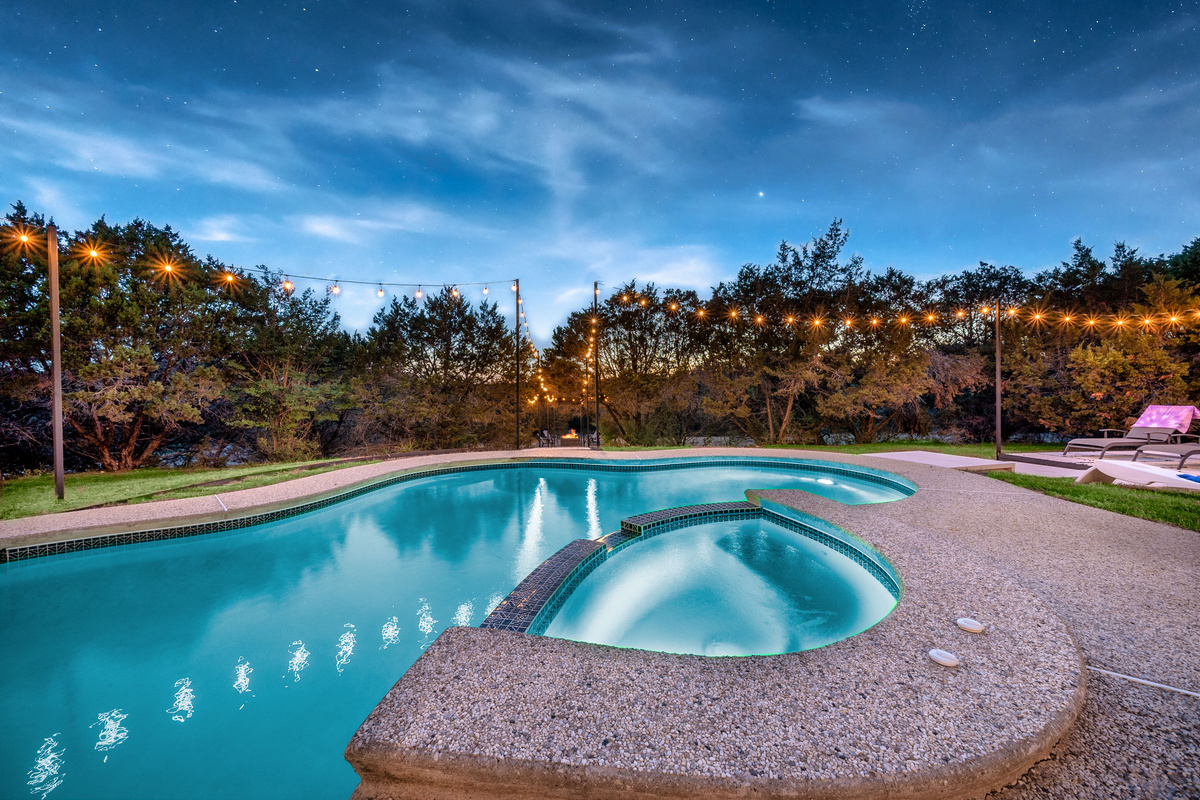 Curved pool design with an attached hot tub — the ultimate relaxation spot.