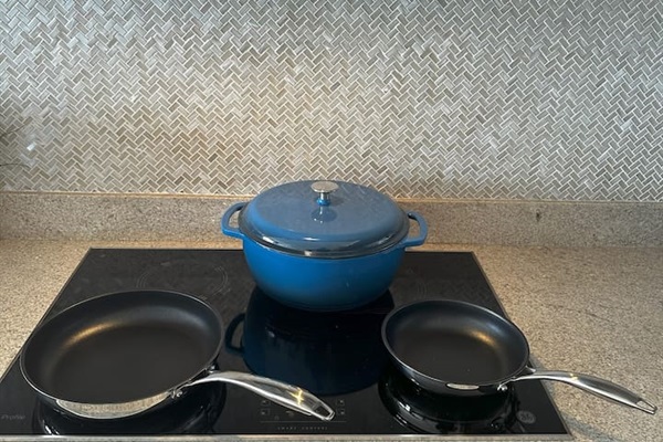 Explore premium fry pans and a stunning blue enameled cast iron Dutch oven (7.3 QT), ideal for creating delicious meals in this modern Cabo kitchen. Prefer not to cook? Inquire about our in-home chefs for a delightful dining experience.