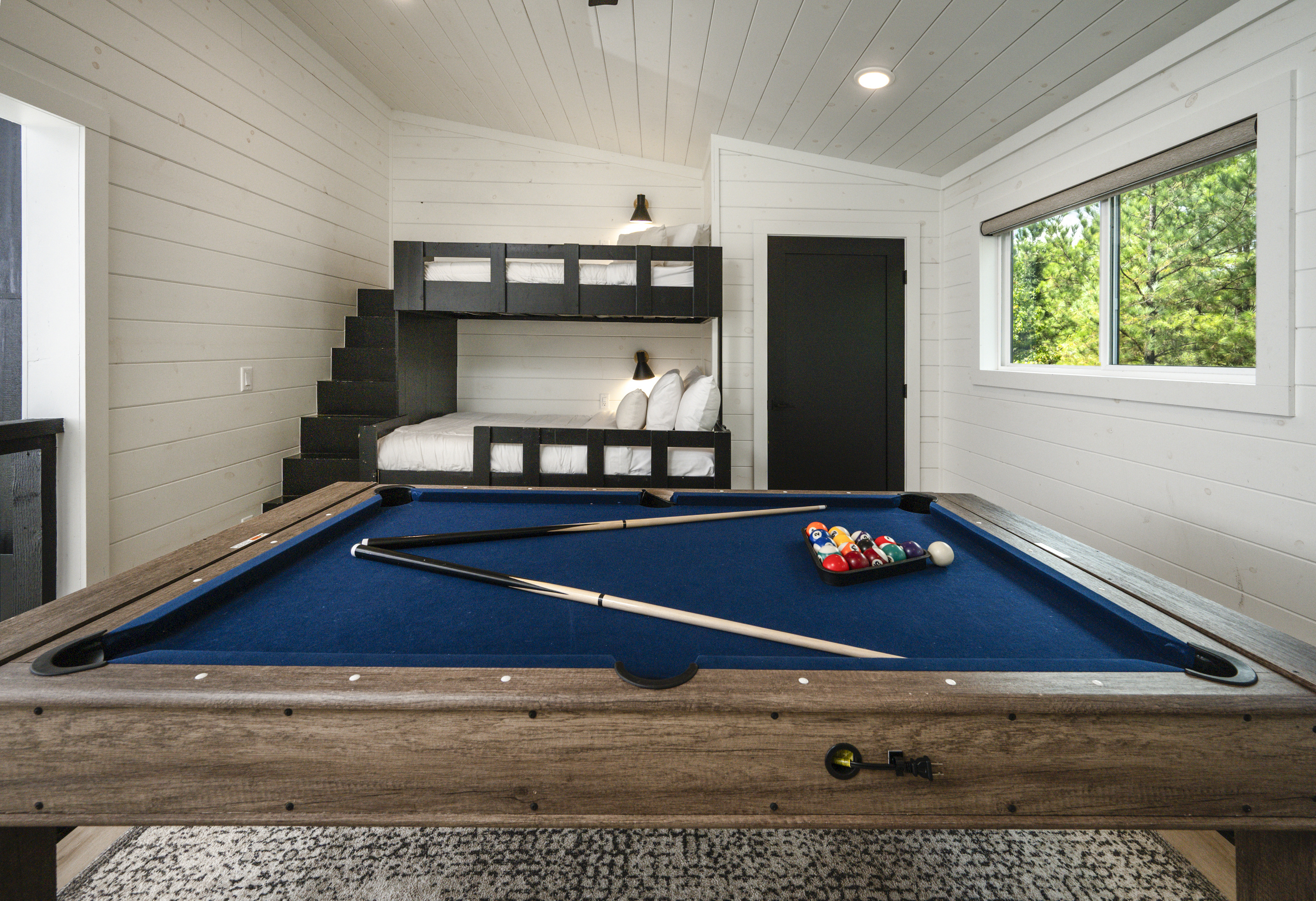 Spacious loft with custom built-in bunk beds and a full-size game table for family fun.