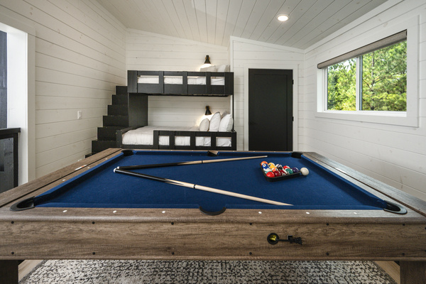 Spacious loft with custom built-in bunk beds and a full-size game table for family fun.