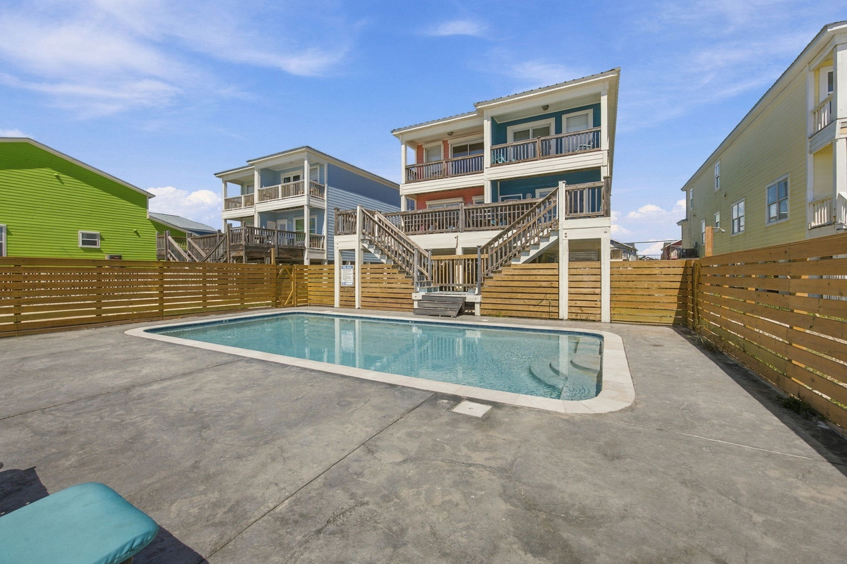 pool with comfortable outdoor seating and a spacious deck for swimming and relaxing.