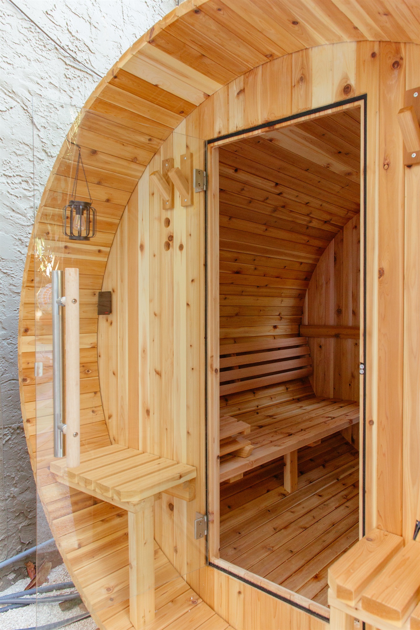 Step into out barrel sauna for a relaxing experience.