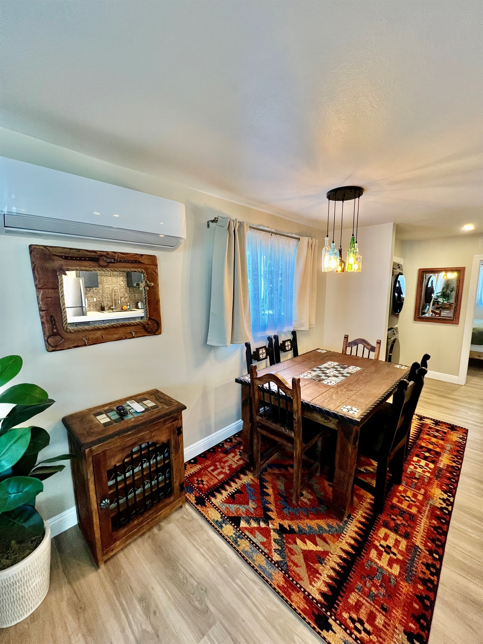 Share a meal at the rustic dining table, featuring stylish pendant lighting