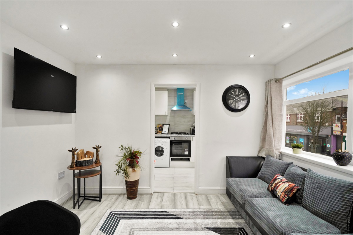 [ppen-plan lounge with Smart TV and kitchen access]