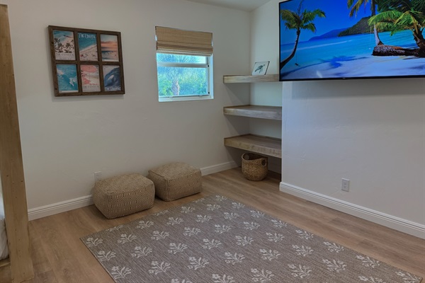 Spacious, airy bunk room with shelves to place your belongings and a 65” smart TV