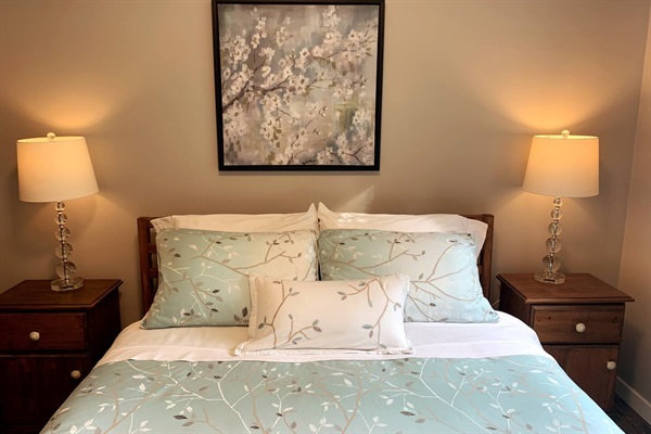 Spacious and bright bedroom with a view overlooking the forest. Blackout cellular blinds and curtains on the window.