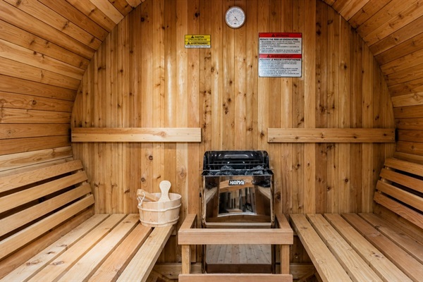 Cedar sauna interior with bench seating and heater—perfect for relaxation