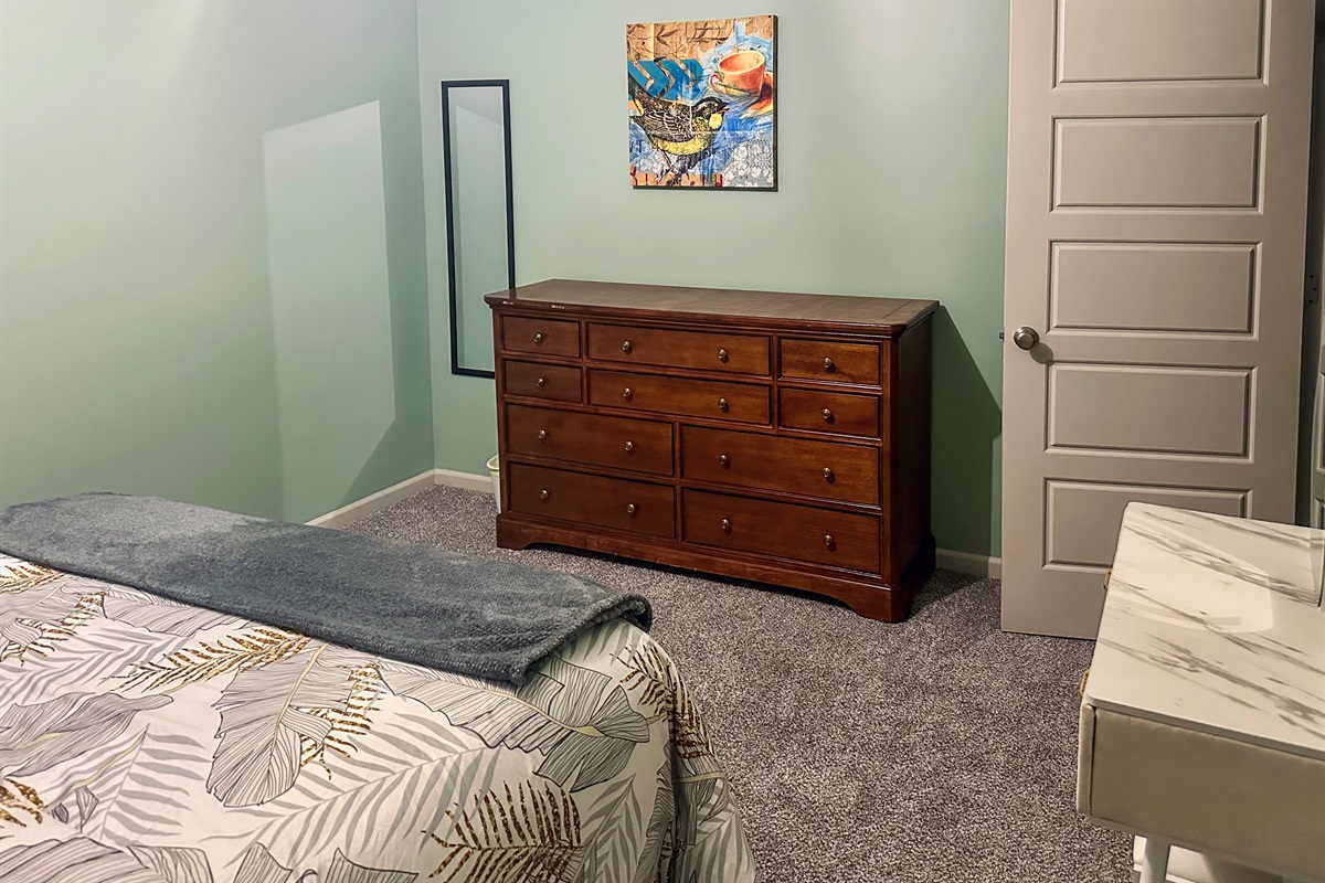 Additional view of the queen bedroom showcasing coordinated furnishings and inviting comfort.