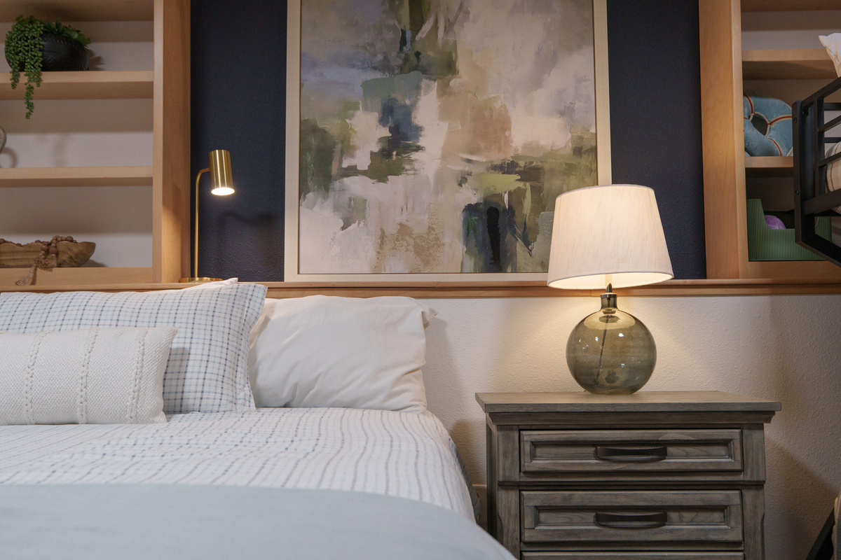 Bedroom 2 is thoughtfully designed for families and groups, featuring a queen bed, a queen-over-queen bunk bed, a dedicated remote-work desk, and a private ensuite bathroom (Bathroom 2)