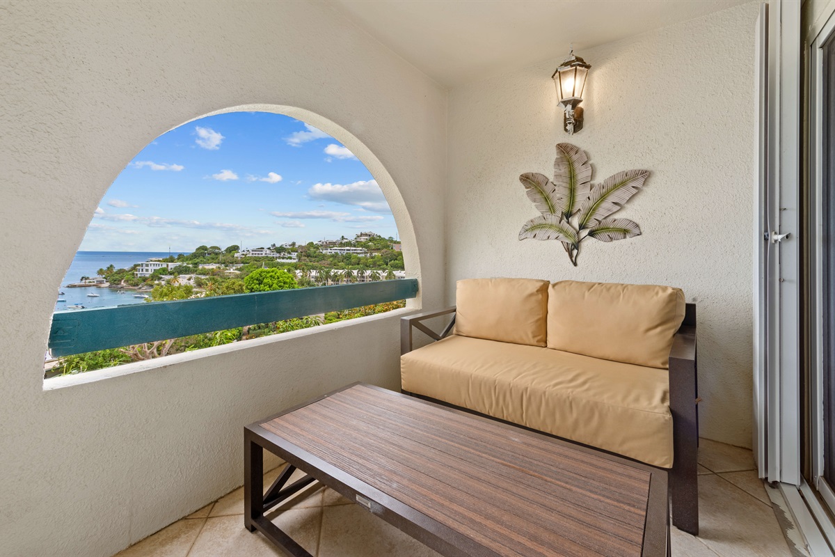 Balcony seating to enjoy refreshing sea breezes and stunning panoramas. This seating area is just off the primary bedroom.