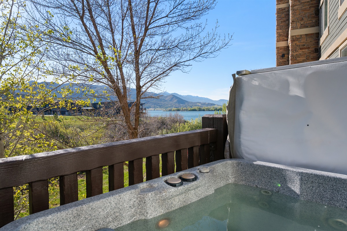 Private hot tub deck with scenic views of Pineview Reservoir — the perfect place to unwind under the Utah sky.