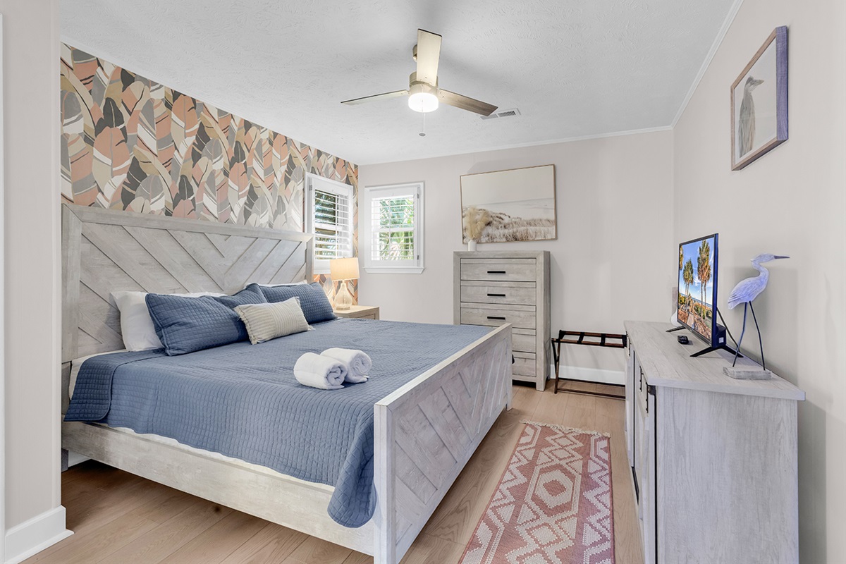 Bedroom 1 with large King bed and beautiful wallpaper backdrop.