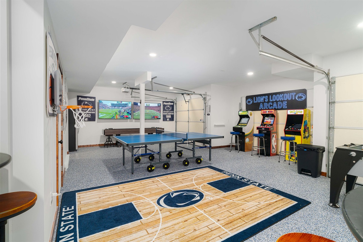 A private arcade and game room with ping pong, shuffleboard, foosball, TVs, and mini-basketball — entertainment built in for all ages.