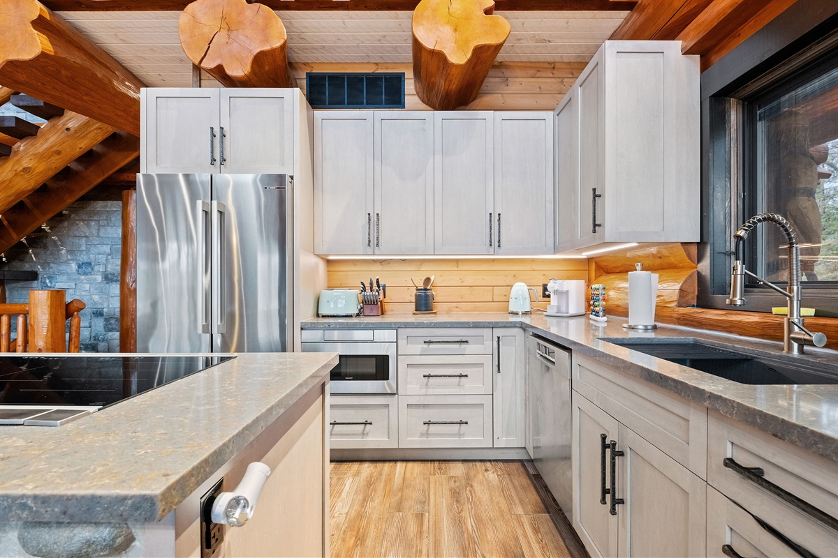 Fully equipped kitchen with premium appliances, cookware, and log-home craftsmanship throughout.