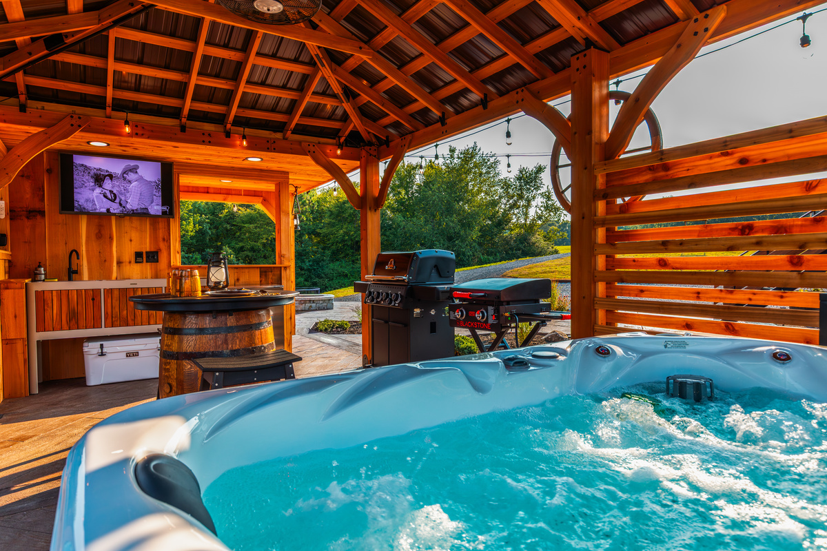 Hot tub, grill, Blackstone griddle, and outdoor TV all together in your private pavilion.