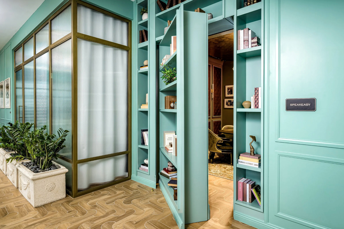 A handsome library and pantry nook in deep-green cabinetry - a quiet retreat to work or share a glass.
