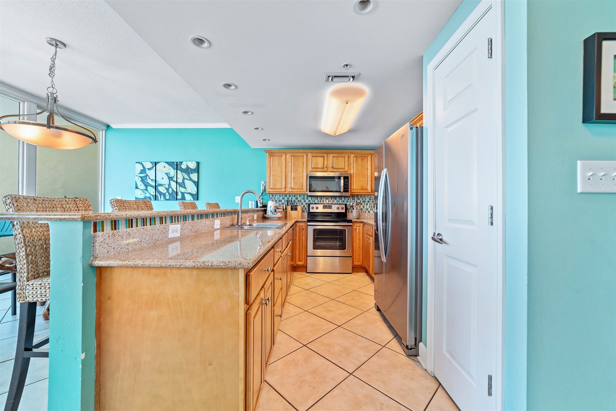 Prepare meals with a side of paradise. This beautifully designed kitchen offers ample space and modern amenities, all while providing stunning, uninterrupted ocean views that extend from the horizon into your culinary experience.
