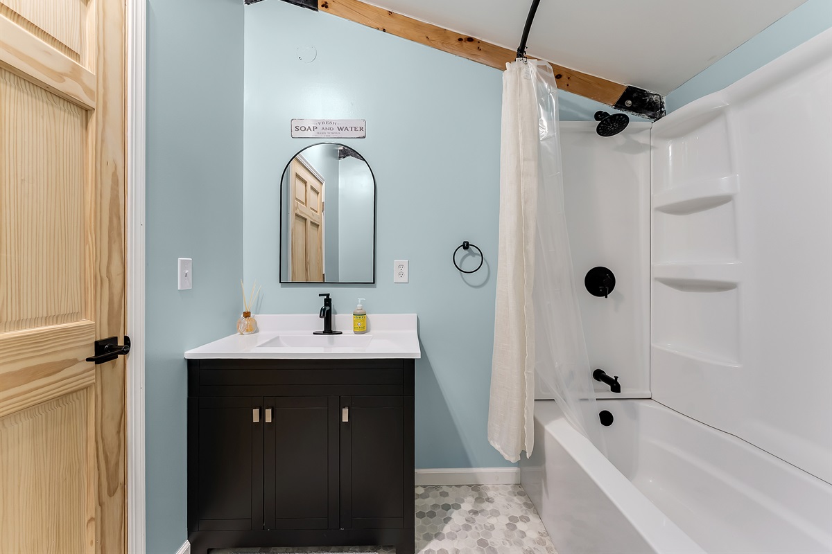 Upstairs full bathroom with bathtub and shower combination.