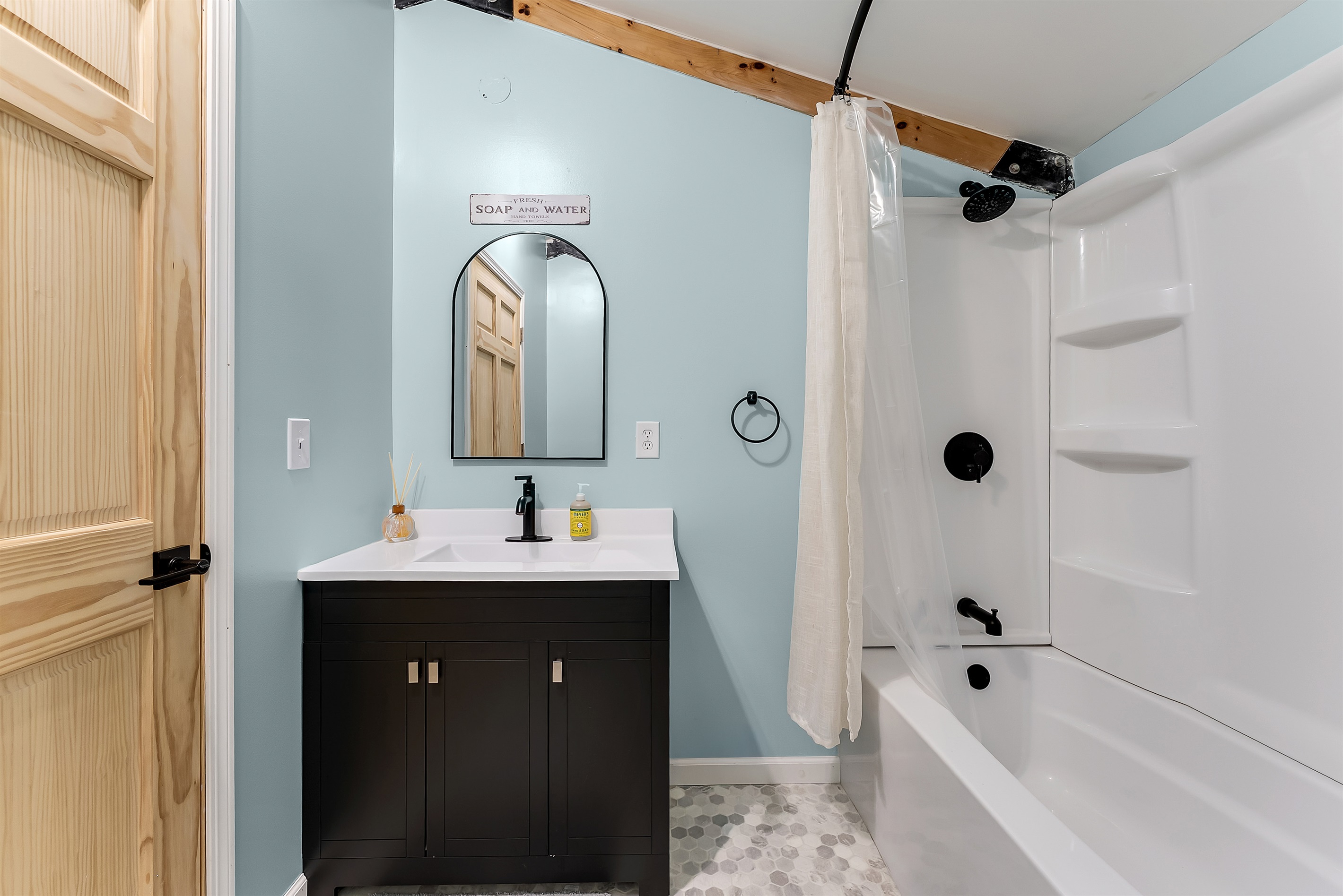 Upstairs full bathroom with bathtub and shower combination.
