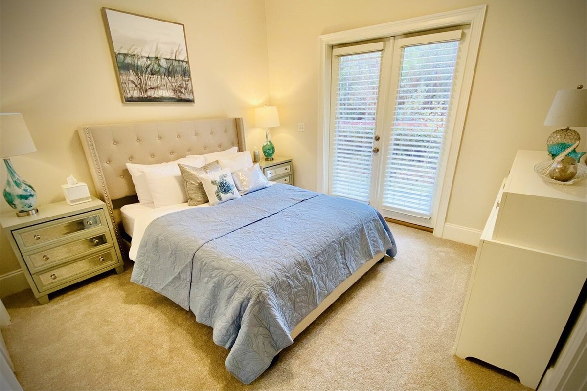 First Floor Bedroom with Queen bed and patio access.