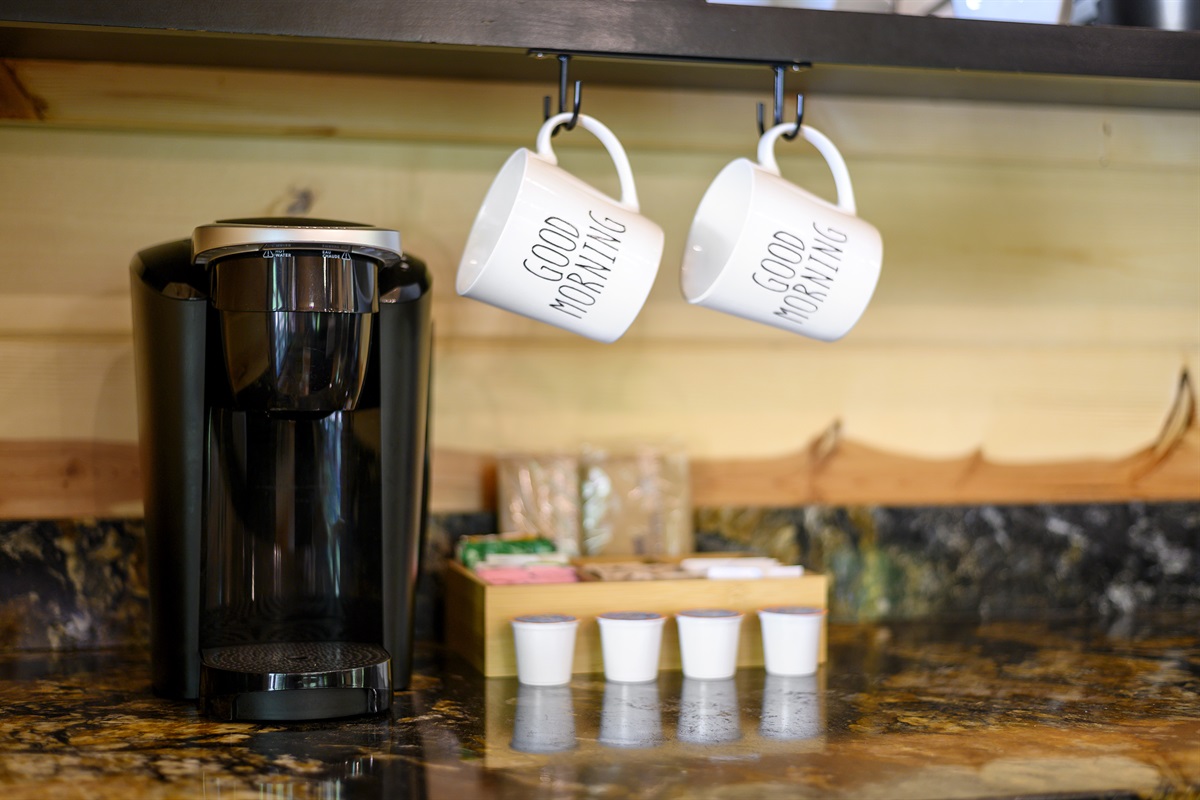 Keurig coffee maker and starter pods provided.