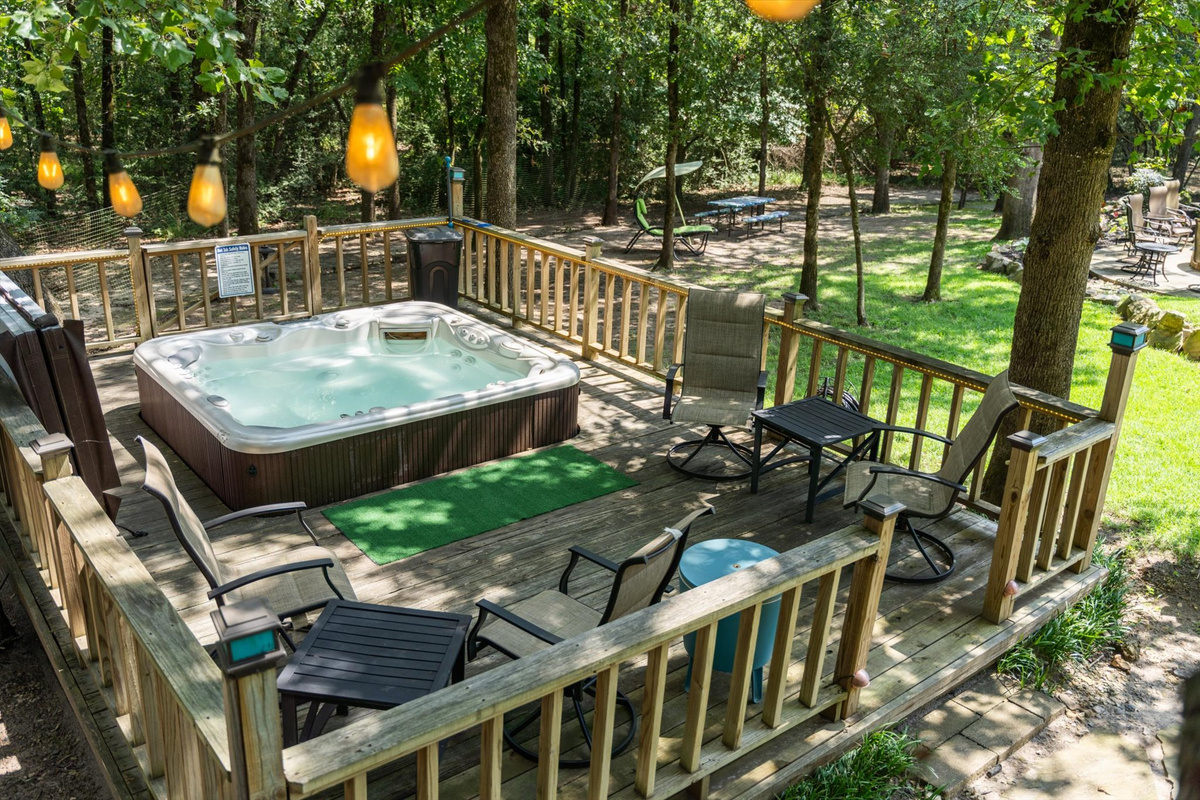 The 6-person hot tub sits on its own private deck, complete with a cooler, chairs, and tables for ultimate relaxation. Open year-round, the perfect spot to unwind.