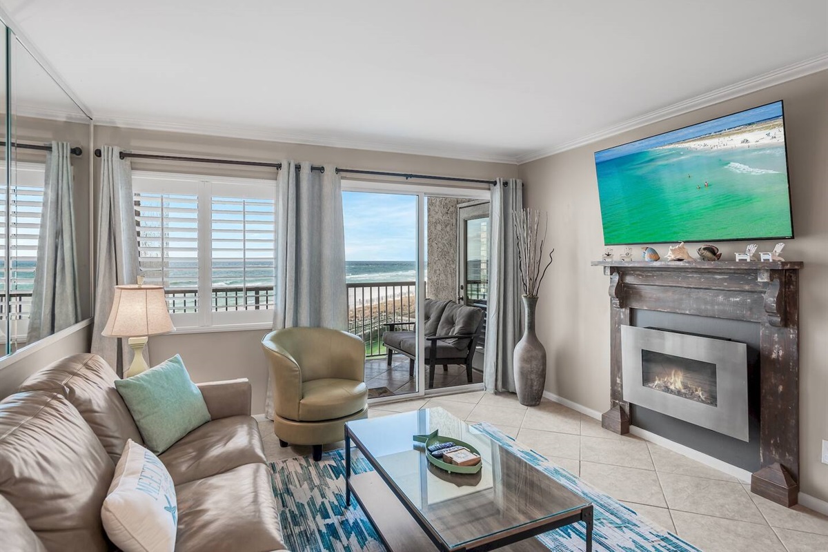 Stylish, spacious living space with GULF views from the 4th story balcony + leather furniture, Queen sleeper sofa, 58" Smart TV, Fireplace, and balcony access